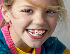 girl with stickables on his invisalign aligners